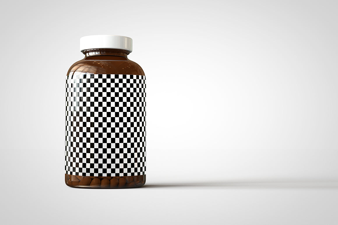 A shiny glass amber supplement/vitamins bottle mock-up full of pills on a white surface with an editable label on the front of the bottle