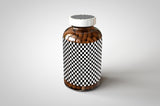 A shiny glass amber supplement/vitamins bottle mock-up full of pills on a white surface with an editable label on the front of the bottle and an editable sticker on the lid