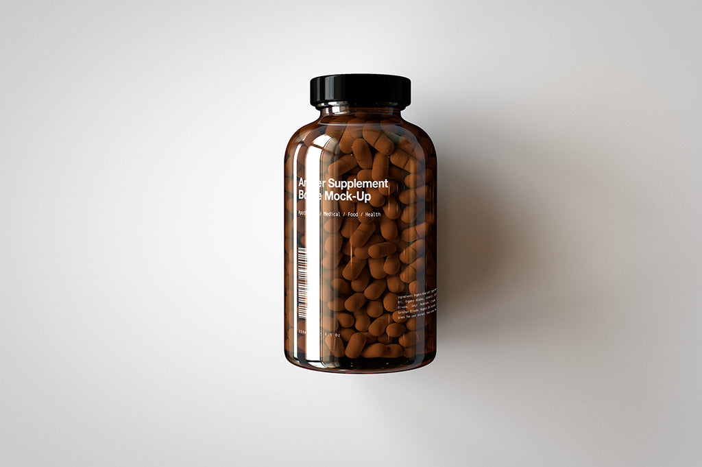 A shiny glass amber supplement/vitamins bottle mock-up full of pills on a white surface with an editable label on the front of the bottle